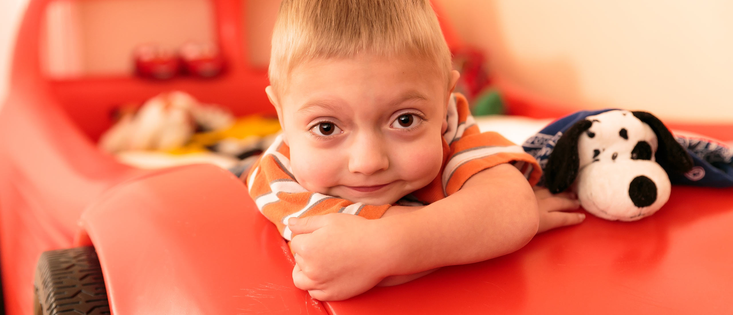 Tanner, diagnosed with HPP at 4 days old, with a stuffed animal