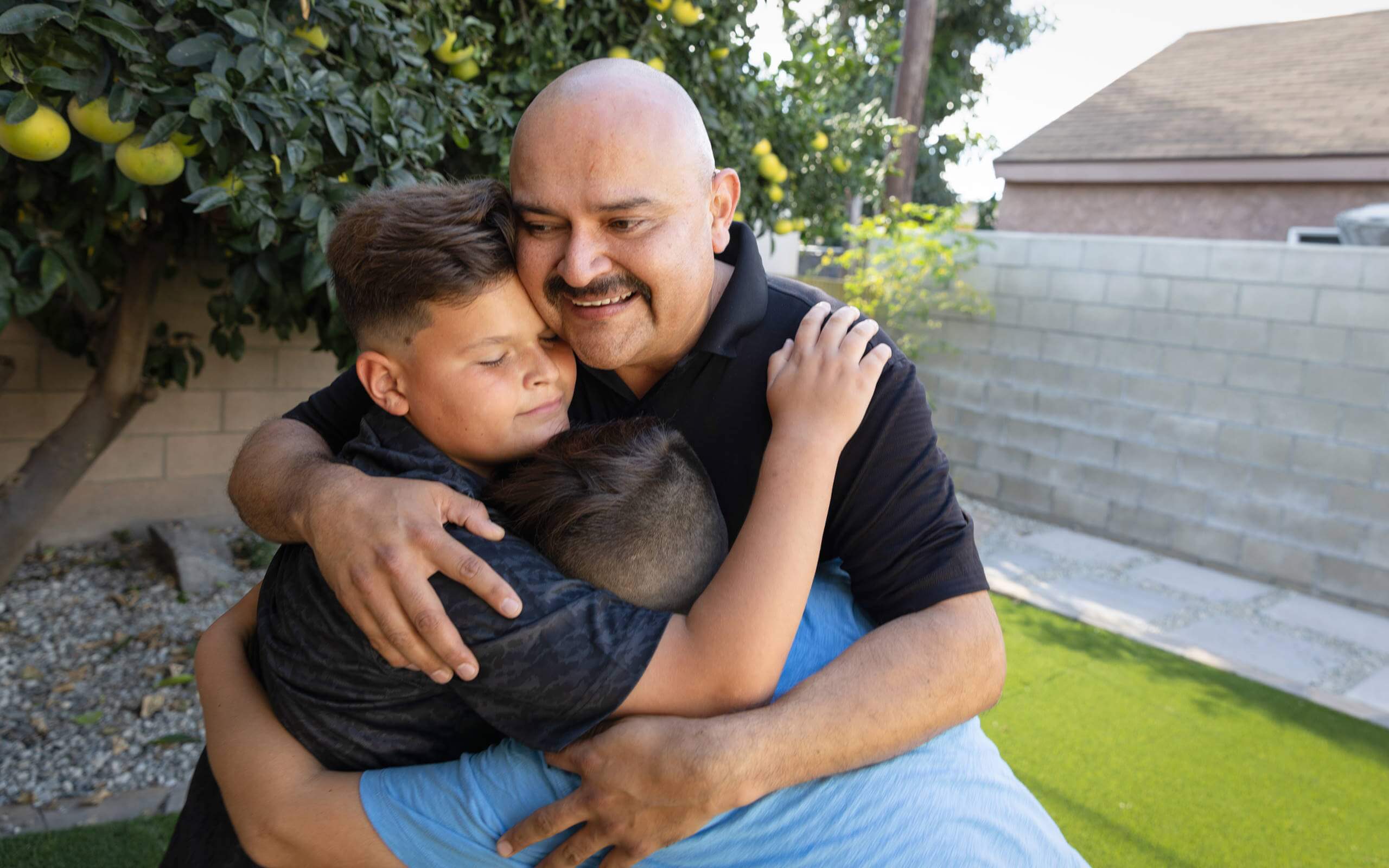 Victor, diagnosed with PNH at 27 years old, hugging his children