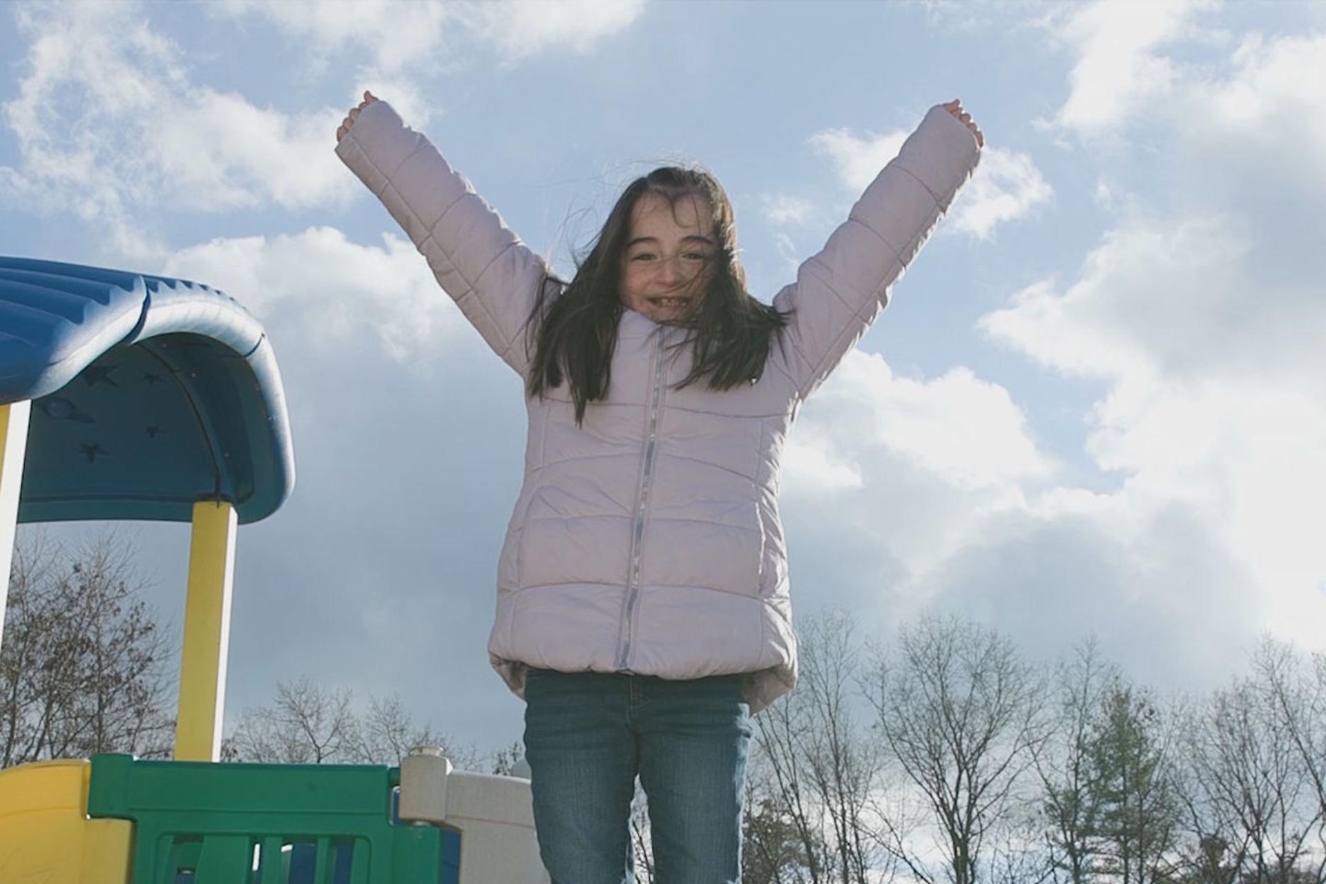 Adelyn with arms up